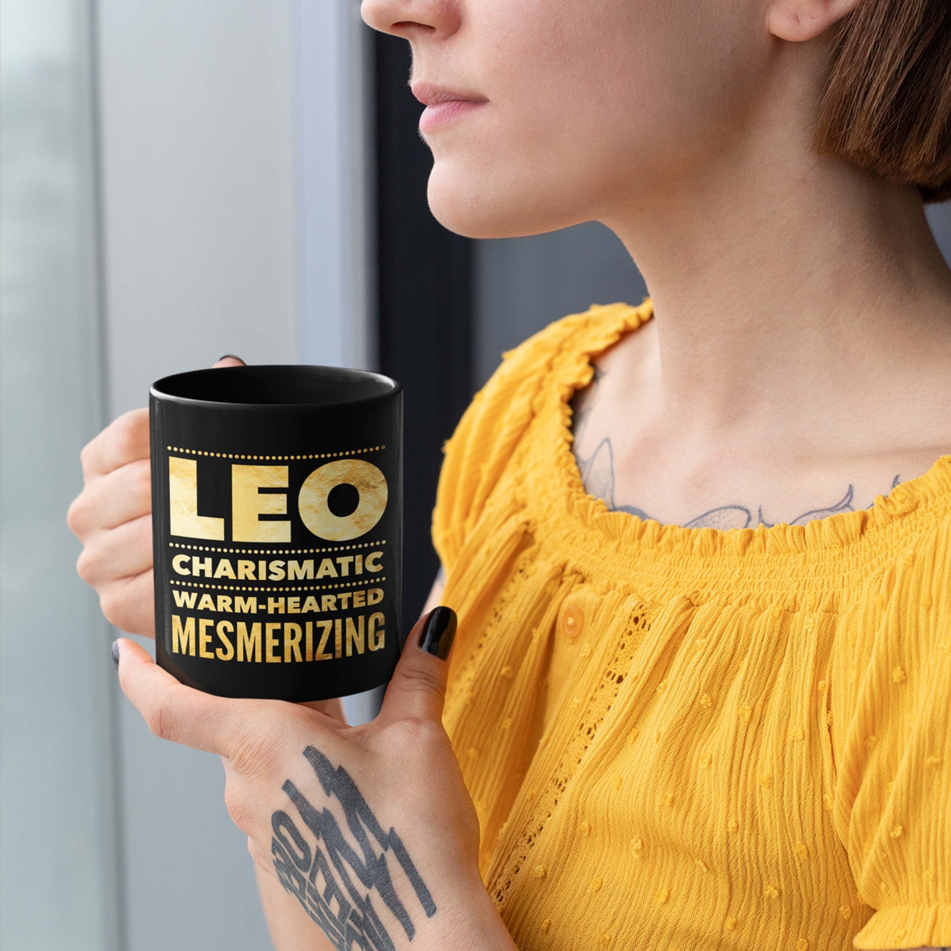 woman holding a leo astrology horoscope quote black mug